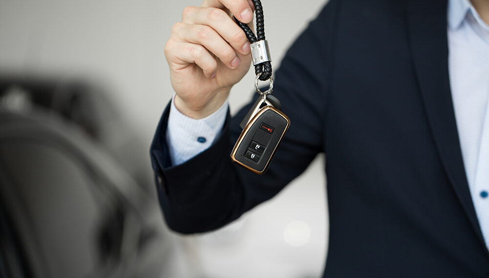 Car dealer with key close-up